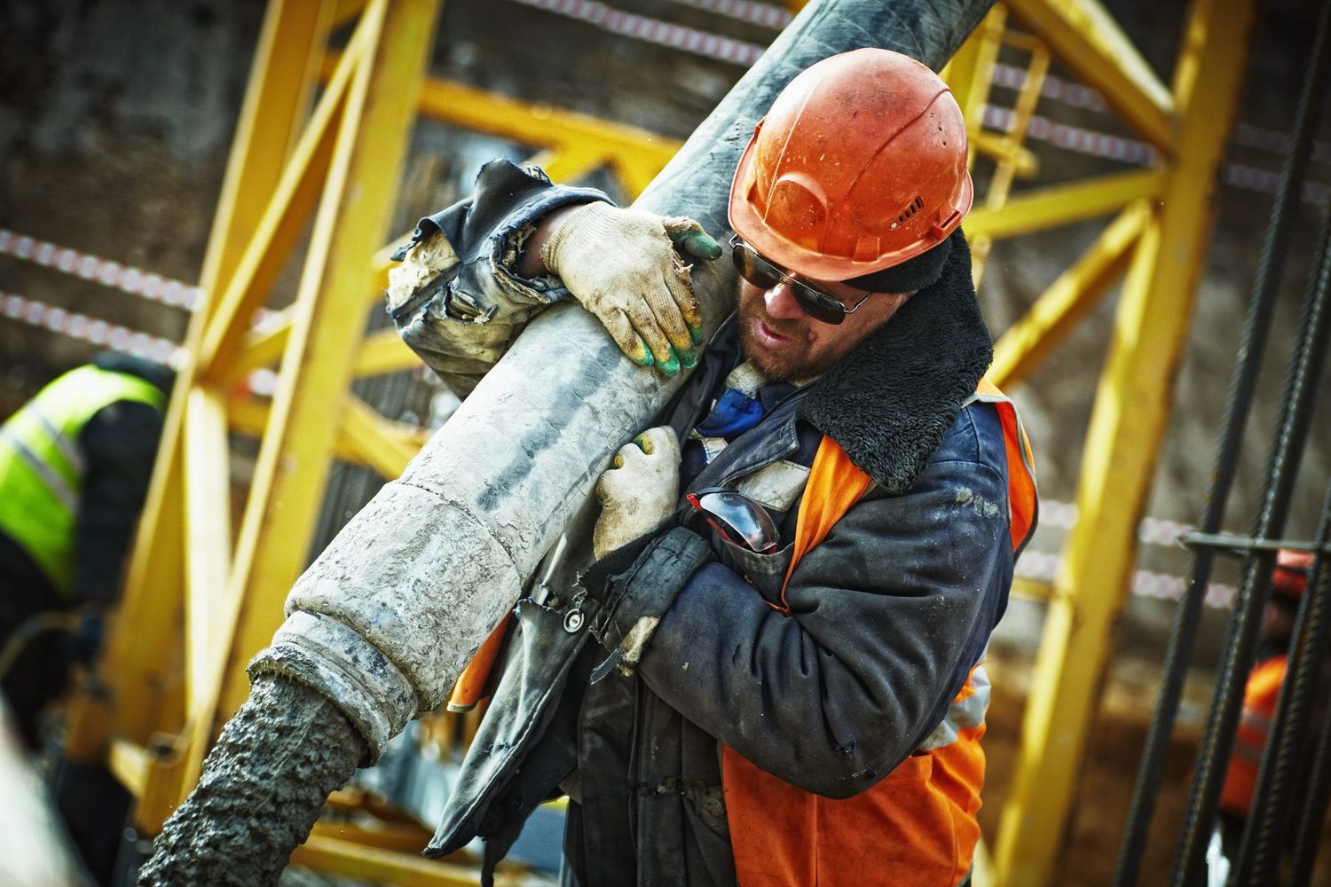 Construction worker pouring concrete on a job site